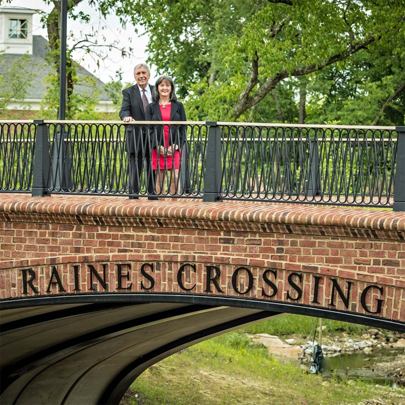 Mr. and Mrs. Raines standing on the Raines Crossing bridge