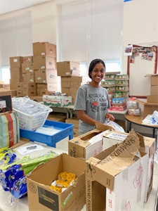 A volunteer sorting miscellaneous items inside the New Albany Food Pantry